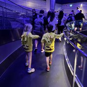 thumbnail for Mia and Bennett in the queue of Test Track at EPCOT