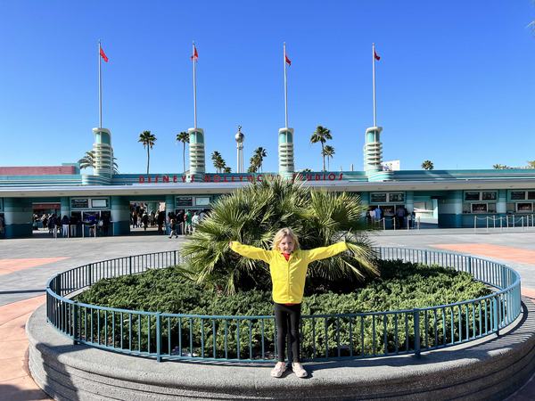 Mia at the front of Hollywood Studios waiting for the Darabans'