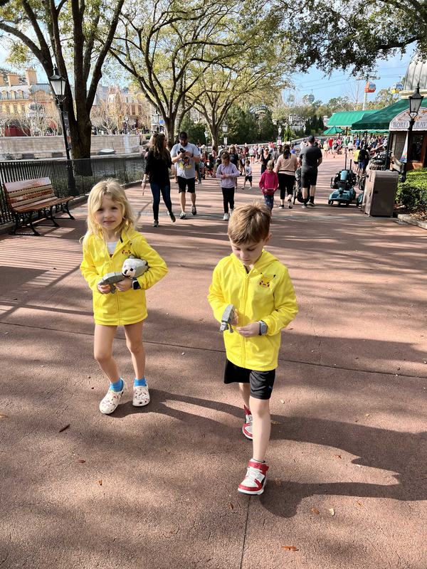 Mia and Bennett walking into EPCOT with matching hoodies