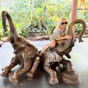 thumbnail for Mia posing with elephant statues at Rafiki's Planet Watch at Animal Kingdom