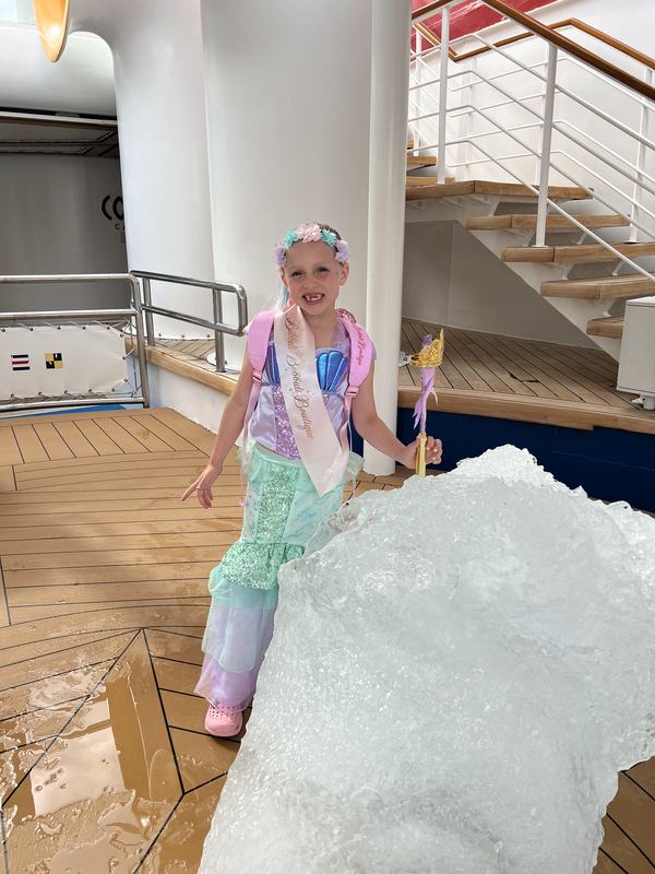 Mia next to glacier ice that was brought on the ship to see