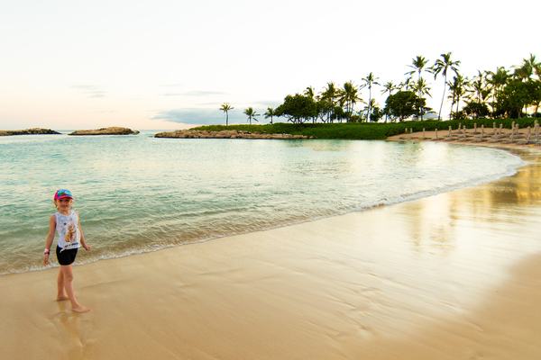 Mia on the beach at Aulani during sunset