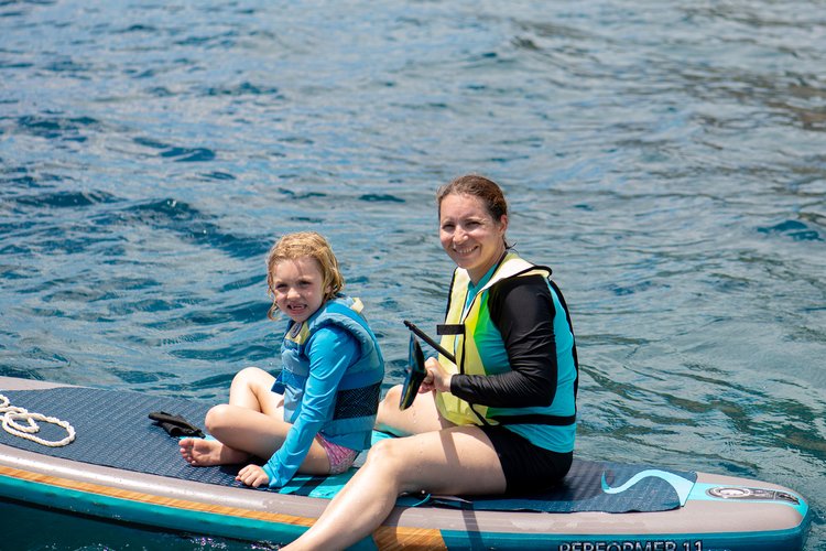 Kati and Mia on a paddle board off the coast of Oahu