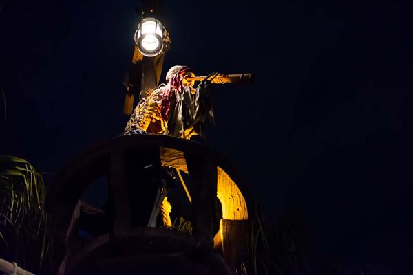 Pirate skeleton in the crows nest near the entrance of Pirates of the Caribbean ride
