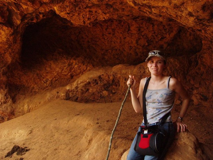 Kati in a cave where elephants go to scrape the walls to get nutrients