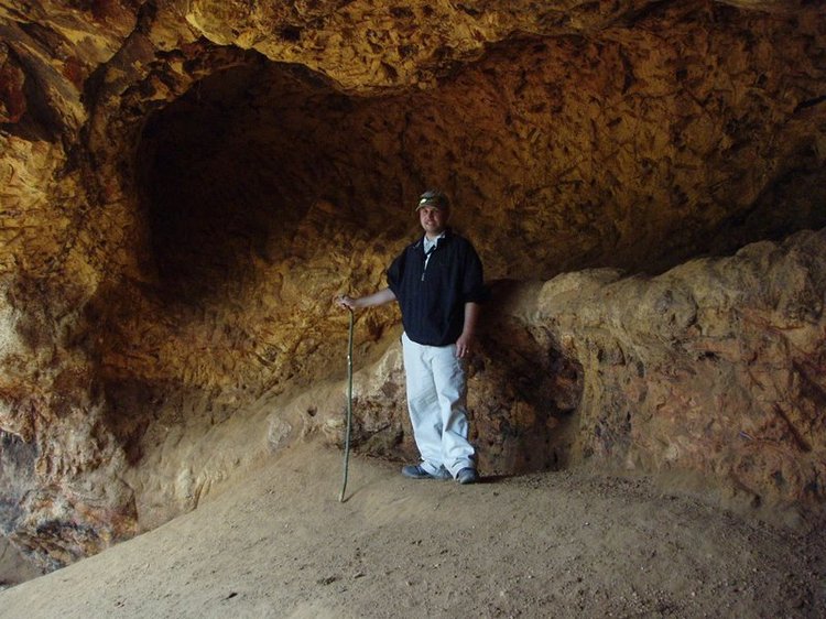 James in a cave where elephants go to scrape the walls to get nutrients