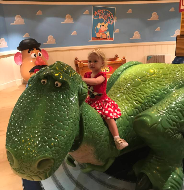 Mia riding Rex on the Disney Cruise Line